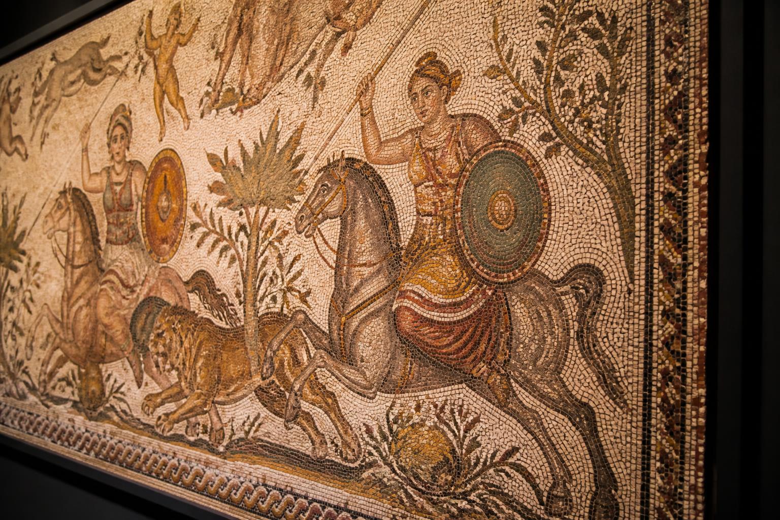 Close-up of the Haleplibahçe Roman mosaic showing Amazon women hunters pursuing prey in detailed coloured stone tiles.